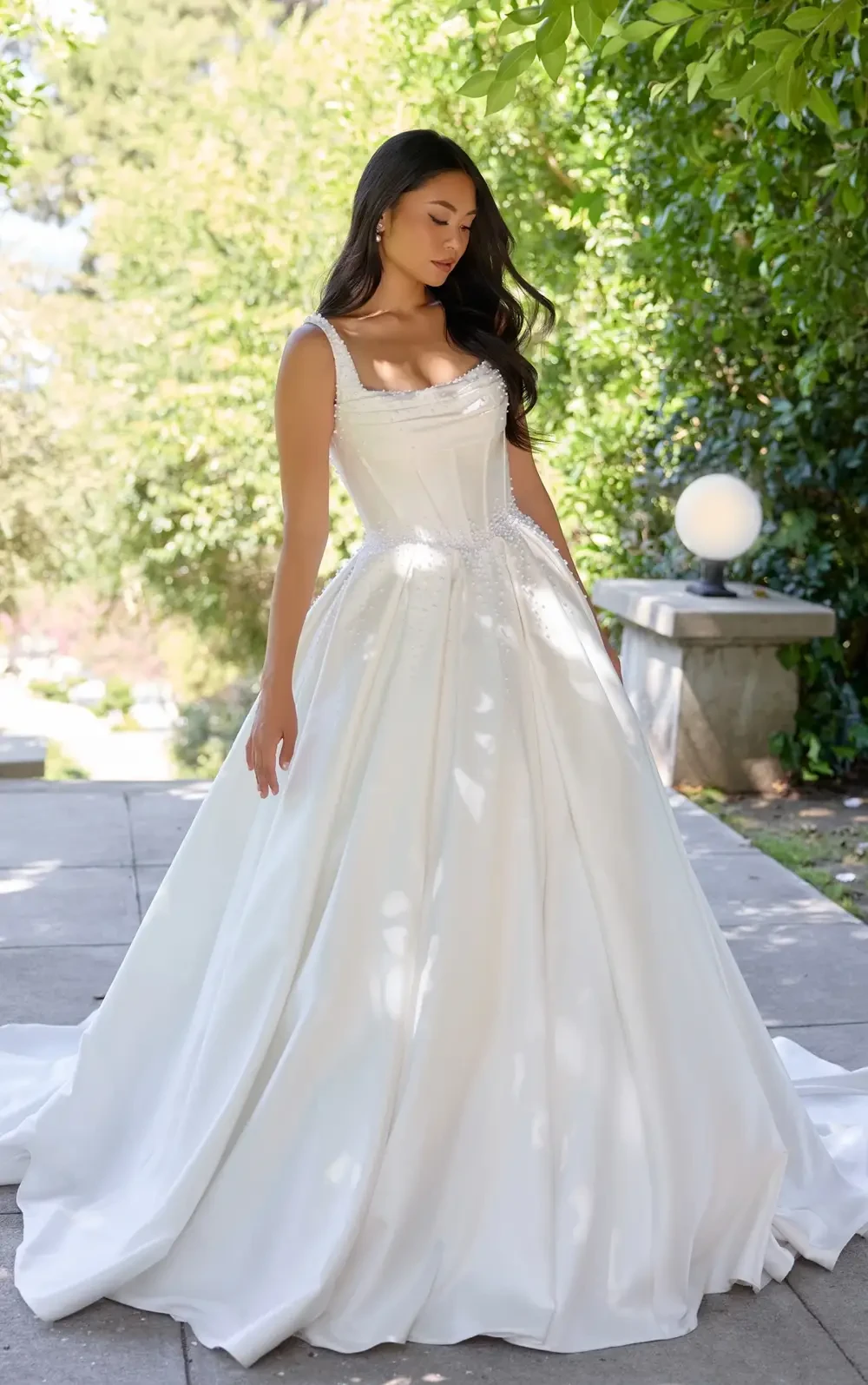 model is wearing a sleeveless bridal gown